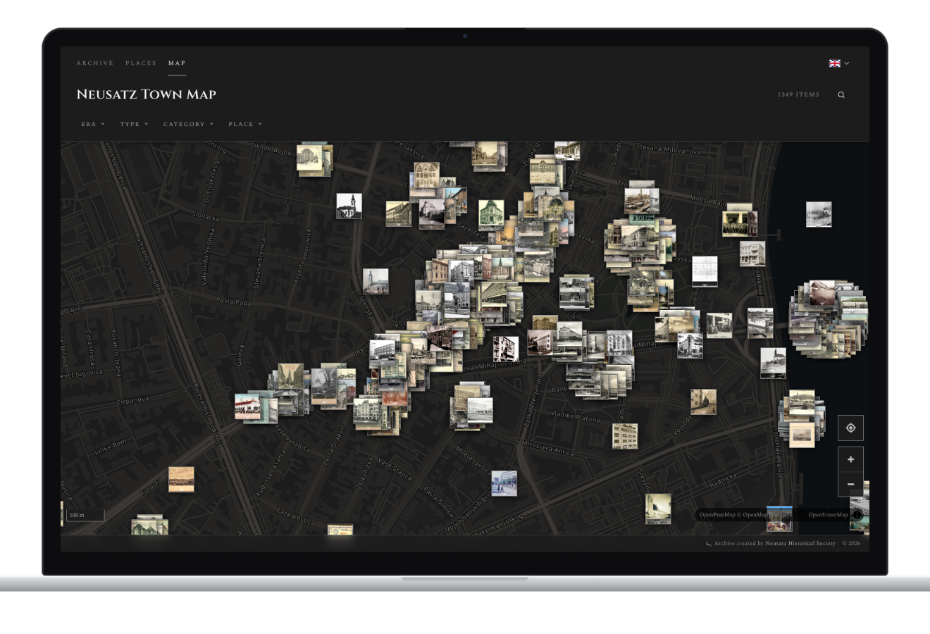 The Neusatz Town Map on a laptop: hundreds of historical photographs pinned over a dark street map of central Novi Sad